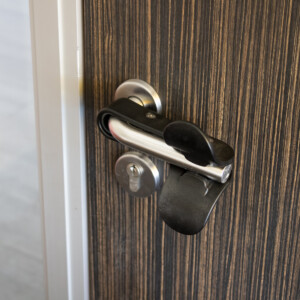 Door secured with black latch and silver handle.