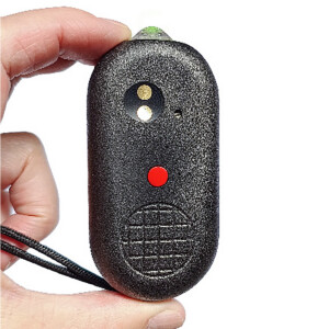 Hand holding black security remote with buttons.